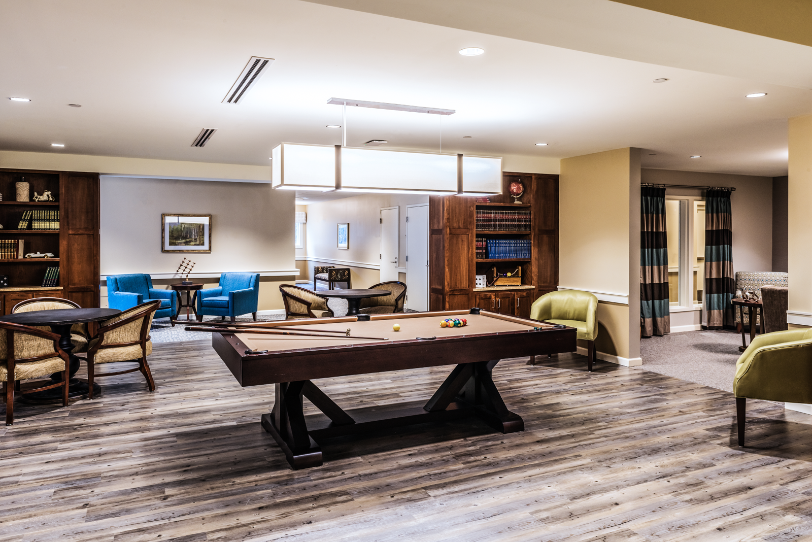 Engaging game room interior design for Massachusetts assisted living community.